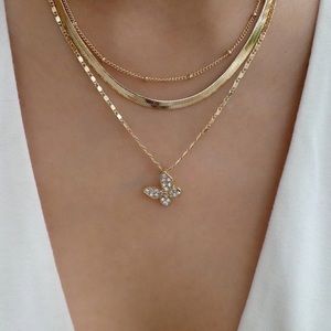 Multi-layer diamond-studded butterfly gold plated necklace.